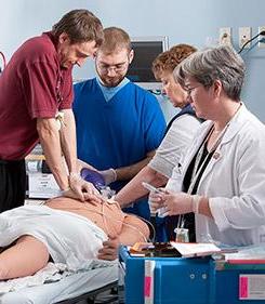Life support students with simulation patient mannequin